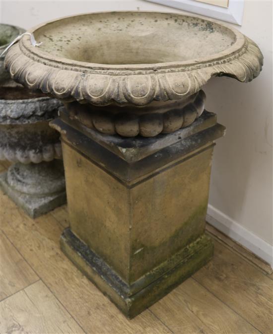 A Victorian terracotta garden urn (reduced), on a square plinth, 66cm wide